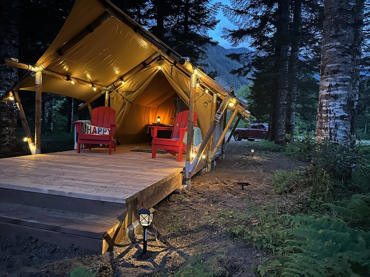 Safari Junior Glamping tent from tm at night with glow lighting.